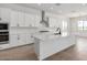 Bright kitchen with white cabinets, stainless appliances, and a kitchen island sink at 25393 N 158Th Ct, Surprise, AZ 85387