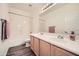 Bright bathroom featuring a double sink vanity and a shower over tub at 2730 W Via Calabria St, Phoenix, AZ 85086