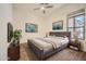 Comfortable bedroom featuring a cozy bed, modern decor, and a ceiling fan for added comfort at 2730 W Via Calabria St, Phoenix, AZ 85086