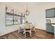 Cozy dining area with a modern light fixture, and natural lighting at 2730 W Via Calabria St, Phoenix, AZ 85086