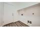 Clean laundry room with overhead shelving for ample storage at 2730 W Via Calabria St, Phoenix, AZ 85086
