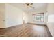Spacious and bright main bedroom with wood-look flooring, ceiling fan, and natural light at 2730 W Via Calabria St, Phoenix, AZ 85086