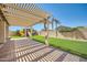 Inviting backyard patio with a pergola, grass, and a playset at 2730 W Via Calabria St, Phoenix, AZ 85086