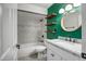 Stylish bathroom features an updated vanity, round mirror, and industrial floating shelves at 2801 E Sylvia St, Phoenix, AZ 85032