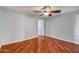 This bedroom features a ceiling fan and rich, attractive hardwood flooring at 2801 E Sylvia St, Phoenix, AZ 85032