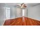 This bedroom features a ceiling fan, hardwood flooring, and multiple access doors at 2801 E Sylvia St, Phoenix, AZ 85032