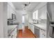 Modern kitchen equipped with stainless steel appliances, marble countertops, and classic white cabinetry at 2801 E Sylvia St, Phoenix, AZ 85032