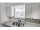 Well-appointed kitchen featuring marble countertops, stainless sink, subway tile backsplash, and garden view at 2801 E Sylvia St, Phoenix, AZ 85032