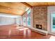 The living room has a stone fireplace, wood ceiling, windows and glass doors to the pool at 2801 E Sylvia St, Phoenix, AZ 85032