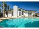 Backyard pool featuring a diving board and outdoor kitchen and white exterior at 2801 E Sylvia St, Phoenix, AZ 85032