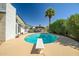 Backyard pool featuring a diving board, mature landscaping, and a cabana at 2801 E Sylvia St, Phoenix, AZ 85032