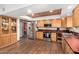 Well-equipped kitchen featuring stainless steel appliances, ample wood cabinetry, and wood-look tile flooring at 2821 W Augusta Ave, Phoenix, AZ 85051