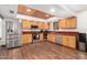 Spacious kitchen featuring stainless steel appliances, wood cabinets, and wood-look tile flooring throughout at 2821 W Augusta Ave, Phoenix, AZ 85051