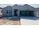 New home construction featuring gray stucco, two-car garage, and desert landscaping at 28228 N Nealite Dr, San Tan Valley, AZ 85143