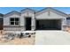 Charming single-story home with a modern design, showcasing its stucco facade and spacious two-car garage at 28228 N Nealite Dr, San Tan Valley, AZ 85143