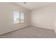Bright, carpeted bedroom with a large window offering natural light at 2834 N Paisley Ln, Casa Grande, AZ 85122