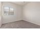 Bright bedroom with a window providing natural light and neutral-colored carpeting throughout the space at 2834 N Paisley Ln, Casa Grande, AZ 85122