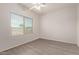 Bright, airy bedroom featuring laminate flooring, a ceiling fan, and a window with blinds at 2834 N Paisley Ln, Casa Grande, AZ 85122