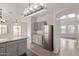 Stylish kitchen with stainless steel refrigerator, granite counters, and modern lighting fixtures at 2834 N Paisley Ln, Casa Grande, AZ 85122