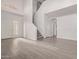 Bright living room with modern flooring, staircase, and an abundance of natural light from large windows at 2834 N Paisley Ln, Casa Grande, AZ 85122