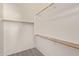 Spacious walk-in closet with multiple wooden rods for hanging clothes and plenty of storage space at 2834 N Paisley Ln, Casa Grande, AZ 85122