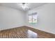 Bright bedroom featuring wood flooring, a ceiling fan, and large window with backyard view at 29618 N 144Th Way, Scottsdale, AZ 85262