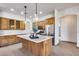 Well-lit kitchen with wooden cabinetry, island with pendant lights, and stainless appliances at 29618 N 144Th Way, Scottsdale, AZ 85262