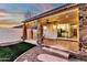 Covered back patio featuring stone pillars, string lights, and sliding glass doors to the interior at 3037 E Bighorn Ave, Phoenix, AZ 85048