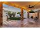 Spacious covered back patio with stone pillars, string lights, and access to the backyard at 3037 E Bighorn Ave, Phoenix, AZ 85048