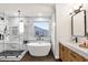 Bathroom showcasing a luxurious stand-alone tub and a separate shower with elegant finishes at 3037 E Bighorn Ave, Phoenix, AZ 85048