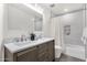 Bathroom featuring double sink vanity and tiled shower and tub at 3037 E Bighorn Ave, Phoenix, AZ 85048