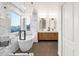 Modern primary bathroom featuring a double vanity and stand-alone tub at 3037 E Bighorn Ave, Phoenix, AZ 85048