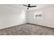 Carpeted bedroom with a ceiling fan and window, providing a simple and comfortable space at 3037 E Bighorn Ave, Phoenix, AZ 85048