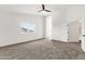 Large bedroom with plush carpet, ceiling fan, and a window that allows for lots of natural light at 3037 E Bighorn Ave, Phoenix, AZ 85048