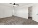 Bright bedroom with a ceiling fan, carpet, and an open closet space at 3037 E Bighorn Ave, Phoenix, AZ 85048