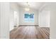 Bright dining room with wood floors, white walls, and a modern light fixture at 3037 E Bighorn Ave, Phoenix, AZ 85048