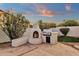 Outdoor kitchen area featuring a fireplace with a stainless steel grill under a colorful sky at 3037 E Bighorn Ave, Phoenix, AZ 85048