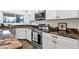 Close-up of a kitchen showcasing granite countertops, stainless steel appliances, and white cabinets at 3037 E Bighorn Ave, Phoenix, AZ 85048