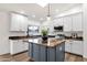 Bright kitchen with granite countertops, stainless steel appliances, a center island, and a skylight at 3037 E Bighorn Ave, Phoenix, AZ 85048