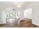 Open concept living room with beautiful hardwood floors, white walls, and bright, natural light at 3037 E Bighorn Ave, Phoenix, AZ 85048