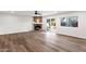 Bright living room with fireplace, wood floors, and sliding glass doors leading to the backyard and pool at 3037 E Bighorn Ave, Phoenix, AZ 85048