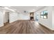 Large living room with stone fireplace, wood floors, recessed lights, and sliding door to outdoor space at 3037 E Bighorn Ave, Phoenix, AZ 85048