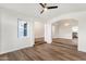 Open-concept living space with wood floors, white walls, and multiple arched doorways at 3037 E Bighorn Ave, Phoenix, AZ 85048