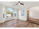 Living area featuring hardwood floors, neutral walls, and a large window with backyard views at 3037 E Bighorn Ave, Phoenix, AZ 85048