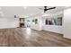 Spacious living room with a stone fireplace, wood floors, ceiling fan, and large windows looking onto the yard at 3037 E Bighorn Ave, Phoenix, AZ 85048