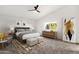 Cozy main bedroom with a ceiling fan, natural light, patterned rug, and modern decor at 3037 E Bighorn Ave, Phoenix, AZ 85048