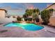Inviting backyard pool with stone waterfall feature and lush landscaping at dusk at 3037 E Bighorn Ave, Phoenix, AZ 85048