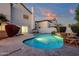 A shimmering swimming pool offers a tranquil backyard oasis with lush greenery and patio area at 3037 E Bighorn Ave, Phoenix, AZ 85048