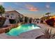 Sparkling pool with rock waterfall, patio, and an outdoor kitchen, perfect for entertaining at 3037 E Bighorn Ave, Phoenix, AZ 85048