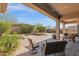 Inviting covered patio with beautiful desert landscaping and stone pavers, perfect for outdoor living at 31085 N 72Nd Pl, Scottsdale, AZ 85266